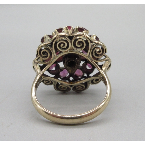 1031 - 18ct yellow gold princess ring set with twenty-one rubies, stamped 18k, size K, 6.6g

Bradleys shipp... 