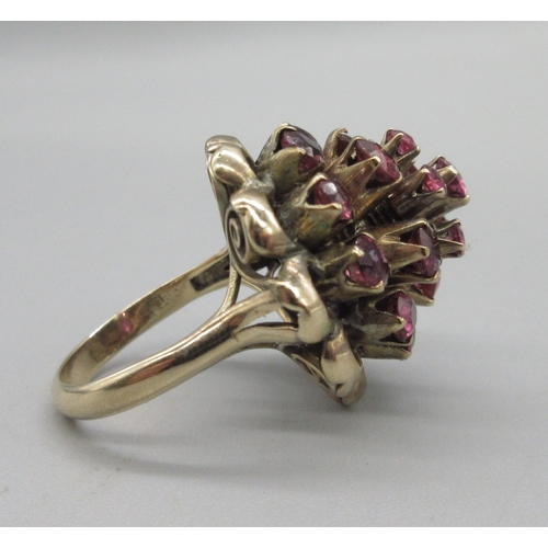 1031 - 18ct yellow gold princess ring set with twenty-one rubies, stamped 18k, size K, 6.6g

Bradleys shipp... 