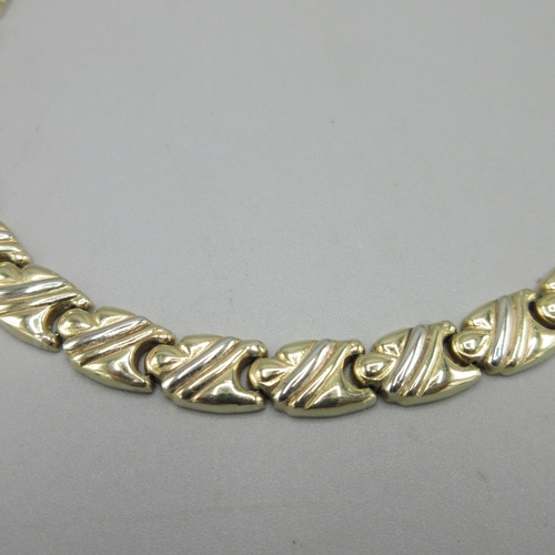 1015 - 9ct yellow and white gold flat puzzle link necklace, stamped 375, L41cm, 26.5g

Bradleys shipping £2... 