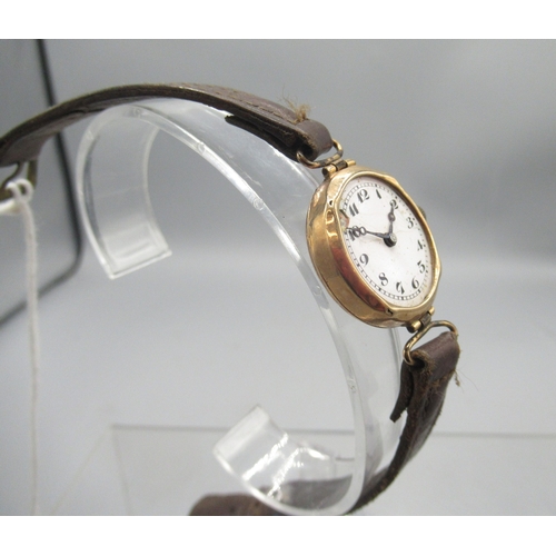 417 - Swiss ladies 9ct gold wristwatch with hinged lugs on leather strap, white enamel Arabic dial, snap o... 