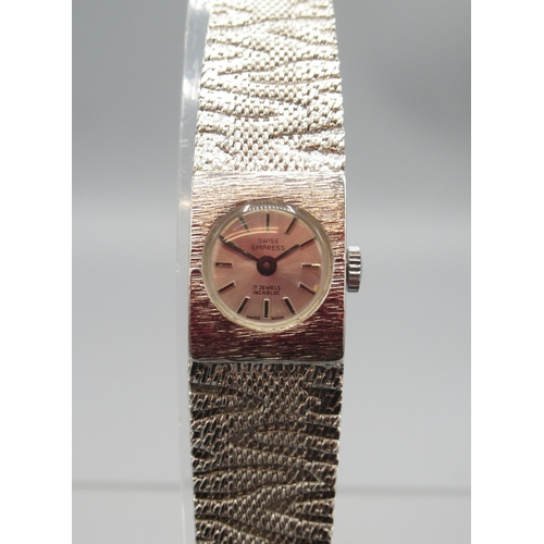 418 - Swiss Empress silver wristwatch on integrated textured bracelet, signed silver sunburst dial with ba... 