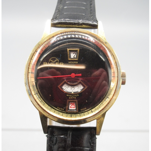 472 - Buler gold plated jump hour wristwatch with date, signed black dial with centre seconds, signed snap... 
