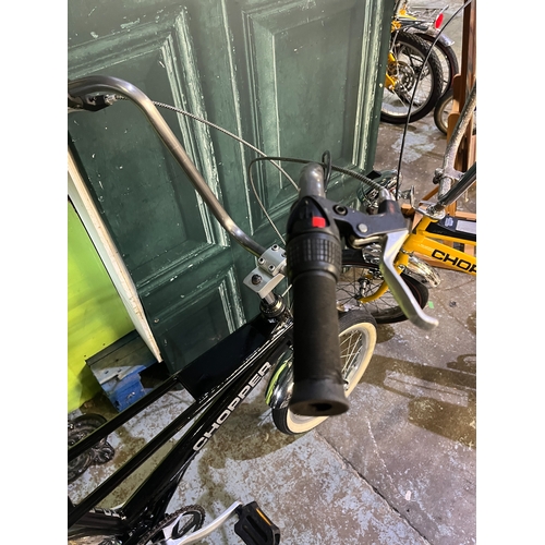 Black Raleigh Chopper style single-speed bicycle, made up of parts