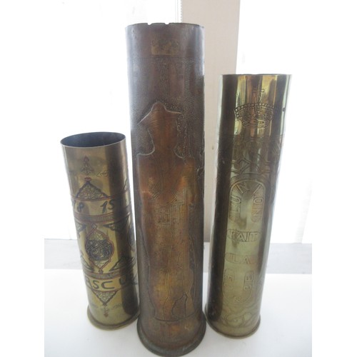 121 - Three decorative brass trench art vases, one with 'Libre' and soldier detailing, one '1918 Damascus'... 