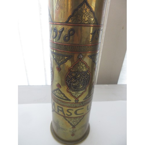 121 - Three decorative brass trench art vases, one with 'Libre' and soldier detailing, one '1918 Damascus'... 