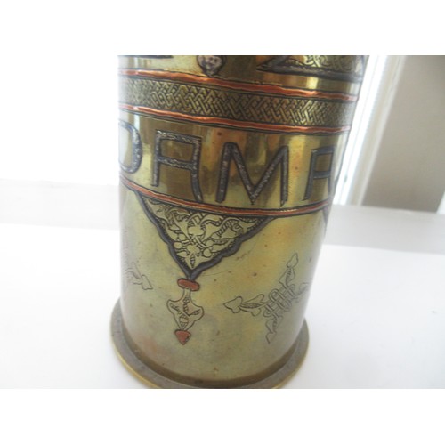 121 - Three decorative brass trench art vases, one with 'Libre' and soldier detailing, one '1918 Damascus'... 