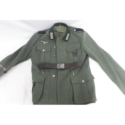 169 - German Army field blouse/tunic with cuff title and wound badge and leather belt

Bradleys shipping £... 