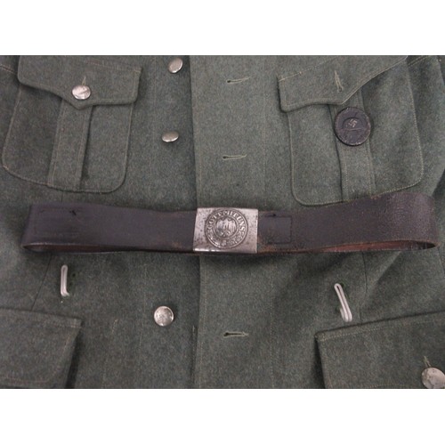 169 - German Army field blouse/tunic with cuff title and wound badge and leather belt

Bradleys shipping £... 