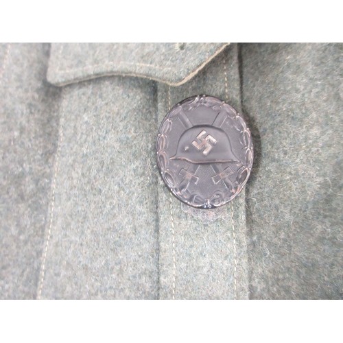 169 - German Army field blouse/tunic with cuff title and wound badge and leather belt

Bradleys shipping £... 