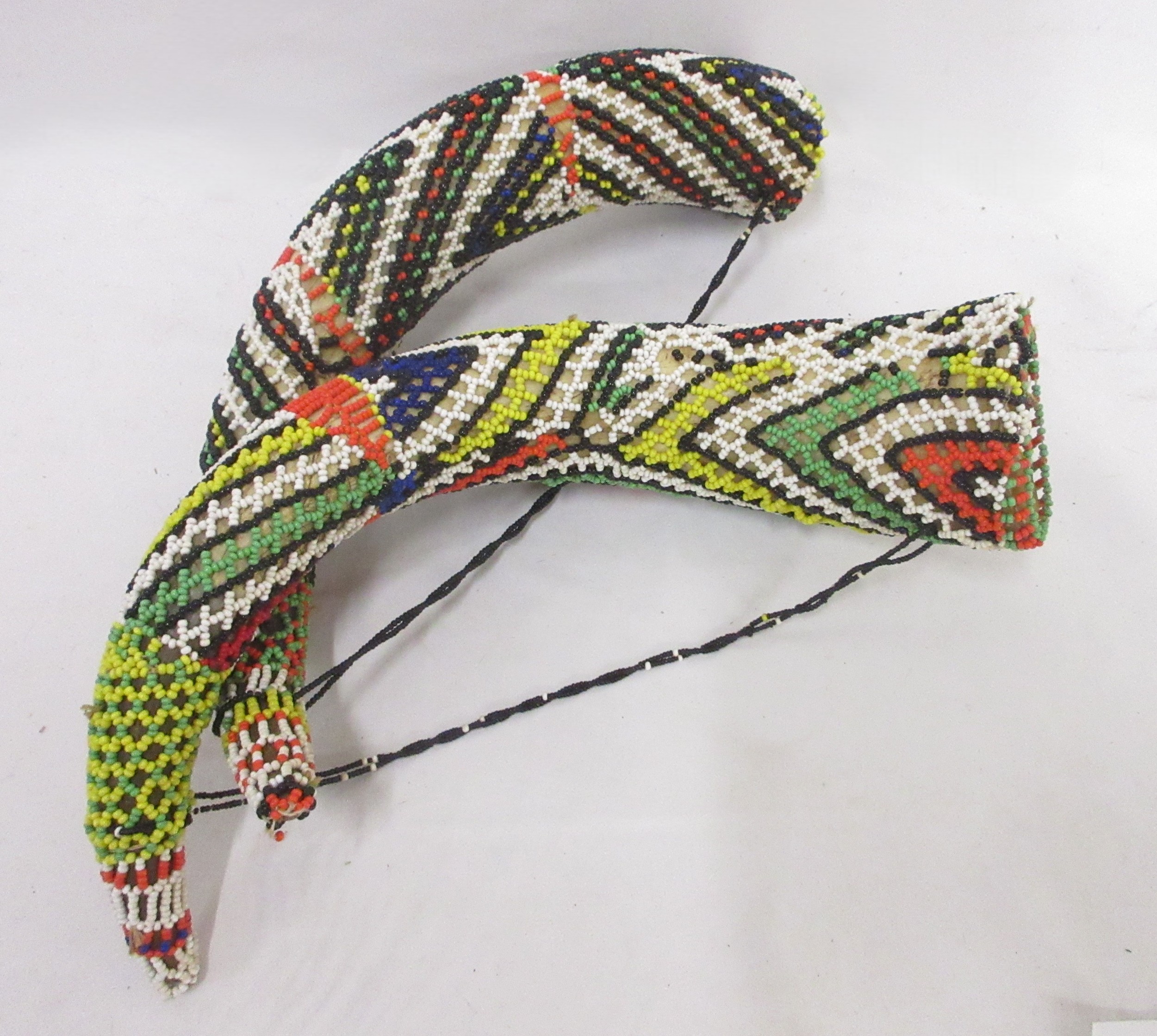African mask, beaded horns, springbok hide, flag, and salt and pepper ...
