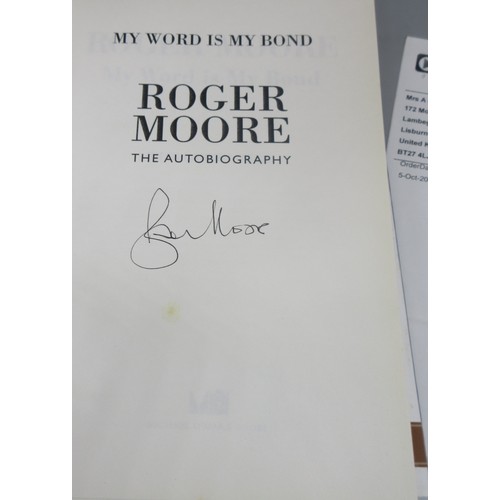 435 - James Bond memorabilia to incl. signed Roger Moore 'My Word is my Bond' book, large Moonraker film p... 