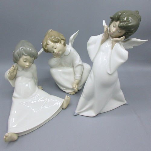 874 - Three Lladro porcelain angelic figures inc. 'Mime Angel' (no. 4959) depicted standing with a puzzled... 