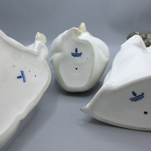 874 - Three Lladro porcelain angelic figures inc. 'Mime Angel' (no. 4959) depicted standing with a puzzled... 