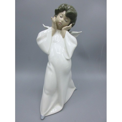 874 - Three Lladro porcelain angelic figures inc. 'Mime Angel' (no. 4959) depicted standing with a puzzled... 