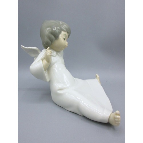 874 - Three Lladro porcelain angelic figures inc. 'Mime Angel' (no. 4959) depicted standing with a puzzled... 