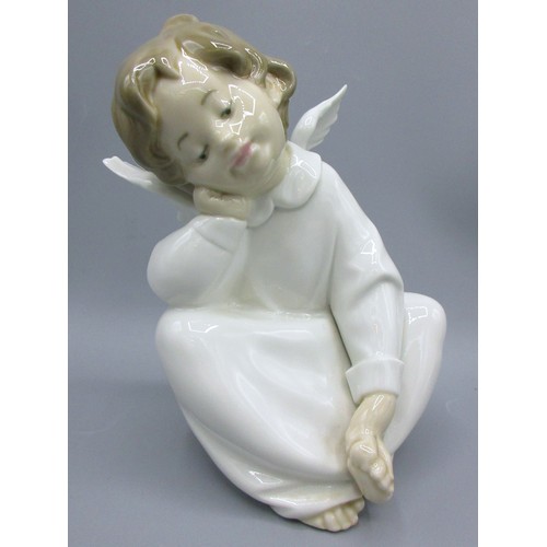 874 - Three Lladro porcelain angelic figures inc. 'Mime Angel' (no. 4959) depicted standing with a puzzled... 