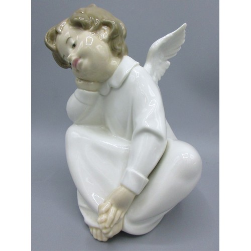874 - Three Lladro porcelain angelic figures inc. 'Mime Angel' (no. 4959) depicted standing with a puzzled... 