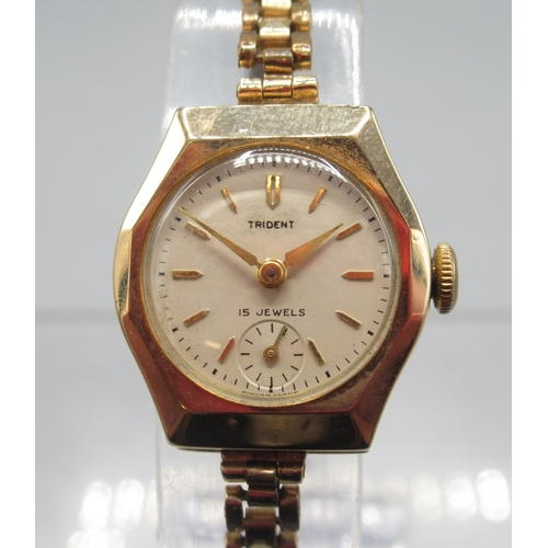 273 - Trident ladies 9ct gold wristwatch on Montal gold plated bracelet, signed cream dial with baton indi... 
