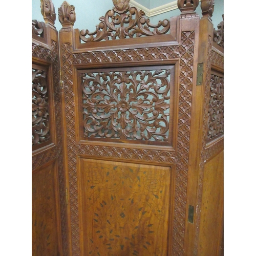 378 - 20th century three fold hardwood screen, the four panels pierced and brass inlaid with carved cresti... 