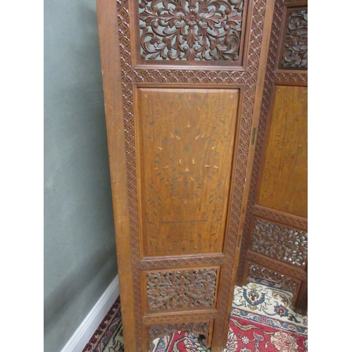 378 - 20th century three fold hardwood screen, the four panels pierced and brass inlaid with carved cresti... 