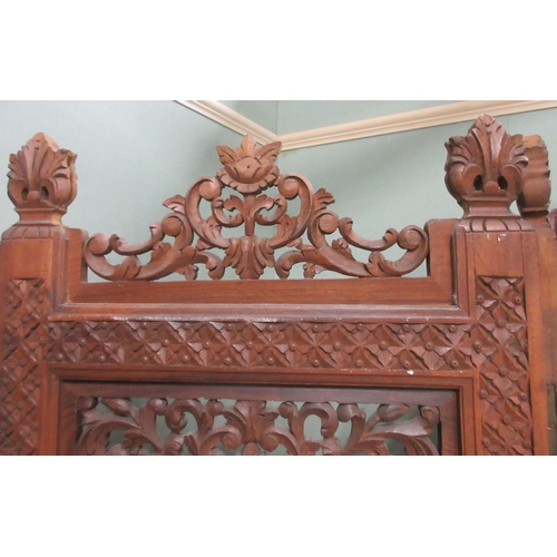 378 - 20th century three fold hardwood screen, the four panels pierced and brass inlaid with carved cresti... 