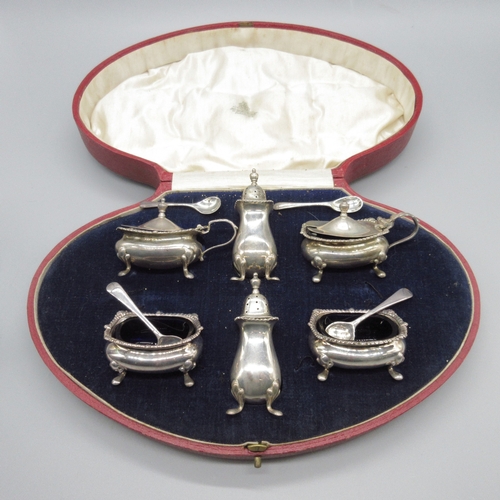 98 - Art Deco silver cruet set to include 2x salt, 2x mustard and 2x pepperette, raised on four cast feet... 