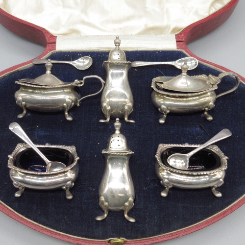 98 - Art Deco silver cruet set to include 2x salt, 2x mustard and 2x pepperette, raised on four cast feet... 