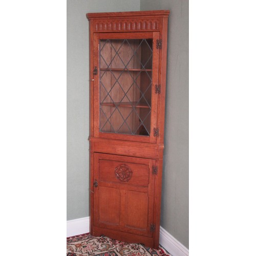 780 - Yorkshire Oak corner cupboard, arcade cornice and lead glazed door above three panel lower door carv... 