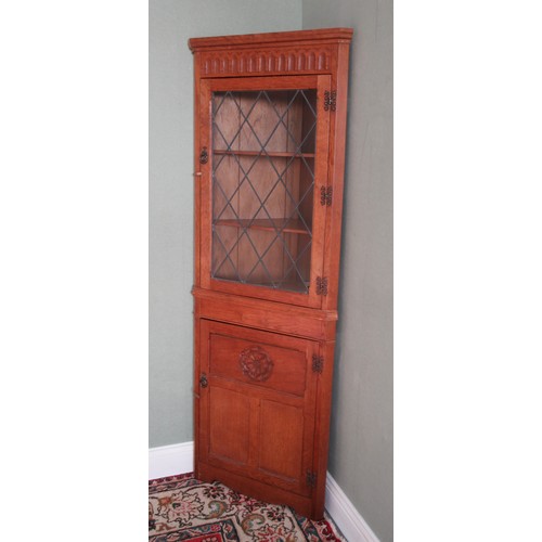 780 - Yorkshire Oak corner cupboard, arcade cornice and lead glazed door above three panel lower door carv... 