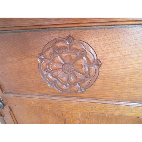 780 - Yorkshire Oak corner cupboard, arcade cornice and lead glazed door above three panel lower door carv... 