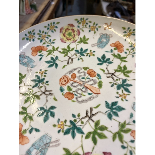 213 - Famillie Rose porcelain dish, hand painted with ribbon tied ruyi scepter bordered by flowers, stampe... 
