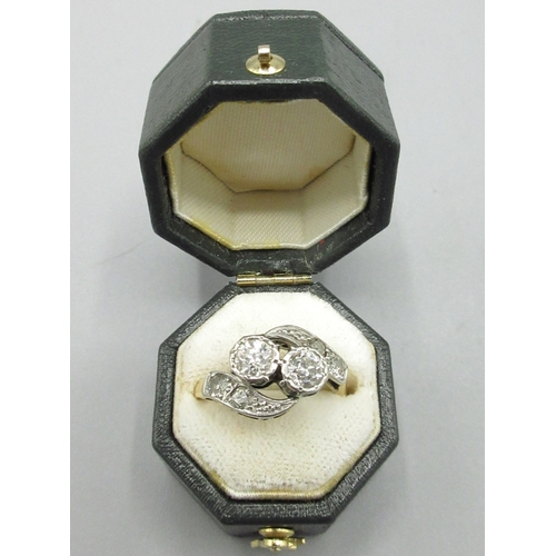 18ct yellow gold and platinum two stone diamond crossover ring, shoulders set with two diamonds each, two central diamonds approximately .35 carat each, hallmarks rubbed, size N, 3.1g  Bradley's Shipping £23.00 plus vat (UK Only)