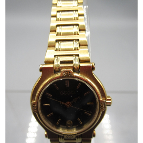 1294 - Gucci ladies gold plated quartz wristwatch with date on matching H link bracelet signed butterfly cl... 