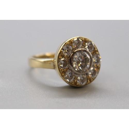 1283 - 18ct stamped diamond target ring comprising 1 large cental stone approx. 1ct and 8 smaller stones ap... 