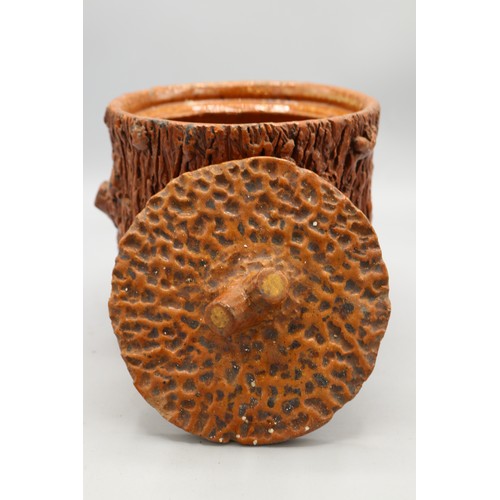 1015 - Barkware earthenware jar with matching lid, decorated with a cut branch motif on the body and formin... 