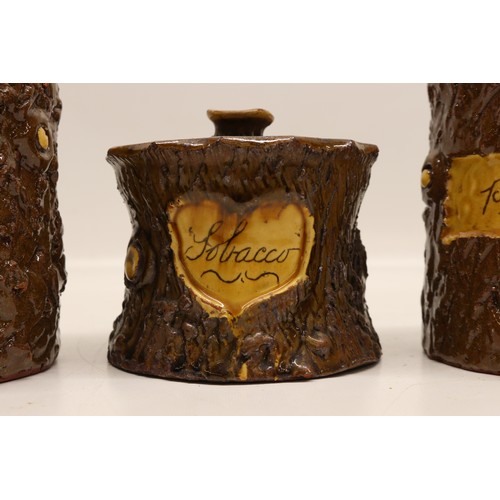 1014 - Three earthenware jars; pair of straight sided jars with cut branch and bark texture surface, one in... 