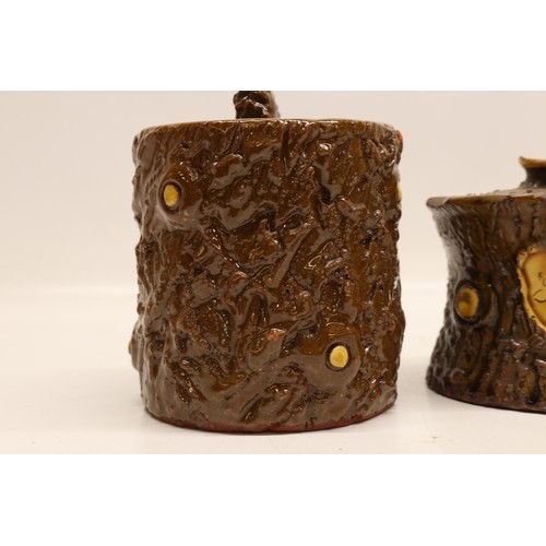 1014 - Three earthenware jars; pair of straight sided jars with cut branch and bark texture surface, one in... 