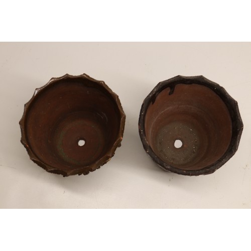 1017 - A pair of earthenware plant pots with matching trays, designed in a barkware style. Each pot feature... 