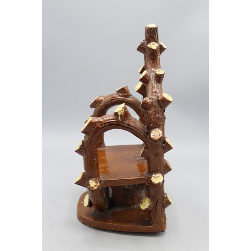1013 - Earthenware bench, with cut branches and bark arms, stand and back details, approx. H22cm, W14cm
Bra... 