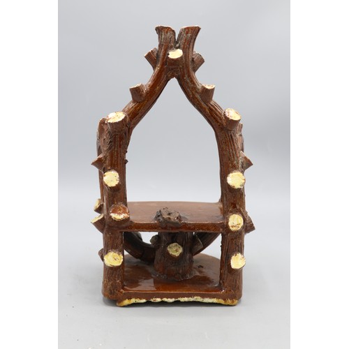 1013 - Earthenware bench, with cut branches and bark arms, stand and back details, approx. H22cm, W14cm
Bra... 