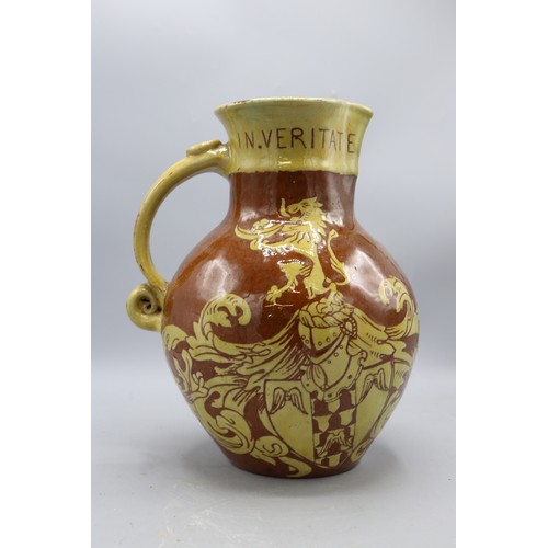 1060 - North Devon slipware harvest jug, scrolled handle, inscribed 'IN VERITATE TRIUMPHO', dated 1904, H24... 