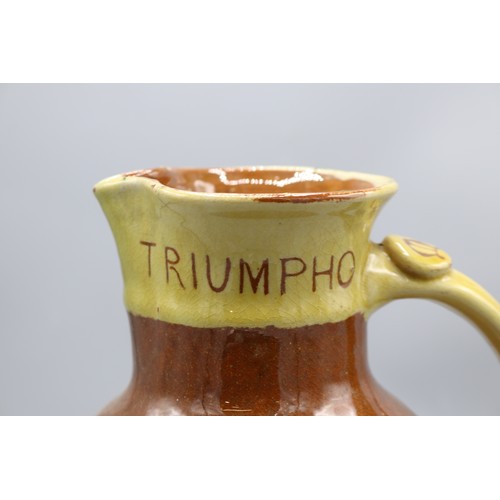 1060 - North Devon slipware harvest jug, scrolled handle, inscribed 'IN VERITATE TRIUMPHO', dated 1904, H24... 