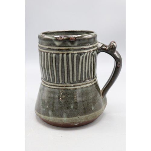1090 - Abuja Pottery stoneware tankard, cylindrical spread form, blue glazed, possibly Ladi Kwali, H15cm
Br... 