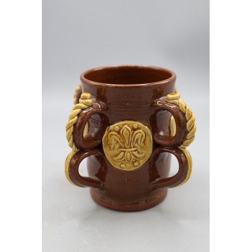 1064 - 19th century replica of a 17th century slipware Wrotham style four handled tyg, four double loop han... 