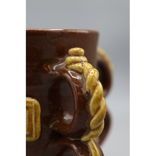 1064 - 19th century replica of a 17th century slipware Wrotham style four handled tyg, four double loop han... 