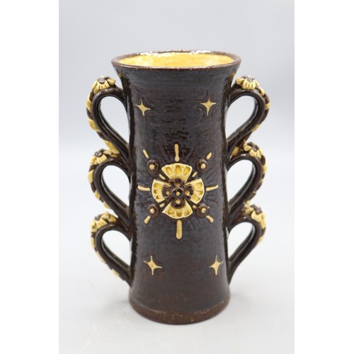 1065 - Wrotham style two handled cup, triple loop handles with rose and rope appliques, rose applique to ce... 