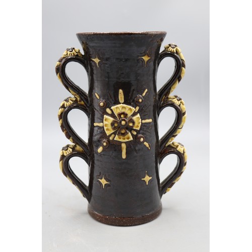 1065 - Wrotham style two handled cup, triple loop handles with rose and rope appliques, rose applique to ce... 