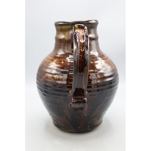 1059 - Charlotte Epton (1902-1970) for Leach Pottery jug, treacle drip glaze, swollen form, scroll detail t... 