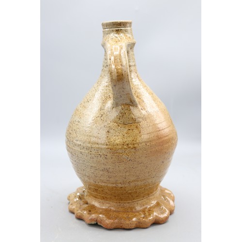 1049 - John Hudson stoneware single handled swollen cylindrical form vase on gadrooned base, H25cm
Bradley'... 