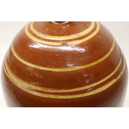 1039 - Slipware flagon, split salt glaze, striped detailing to top portion, cylindrical form, missing handl... 